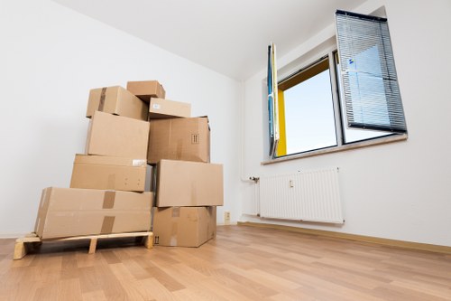 Quote paperwork beside moving boxes in Pimlico