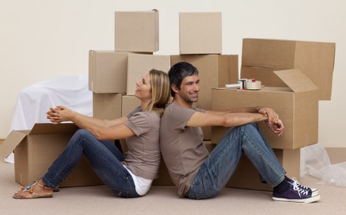 Packed moving boxes and furniture prepared for a Pimlico home removal