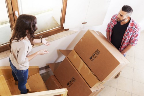 Removal team carrying household items through a central London residential building