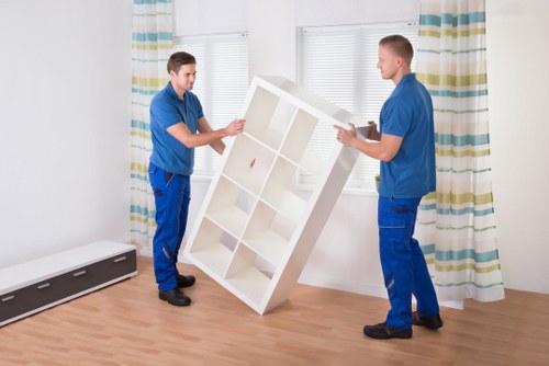 Careful carrying of furniture through a Pimlico flat staircase